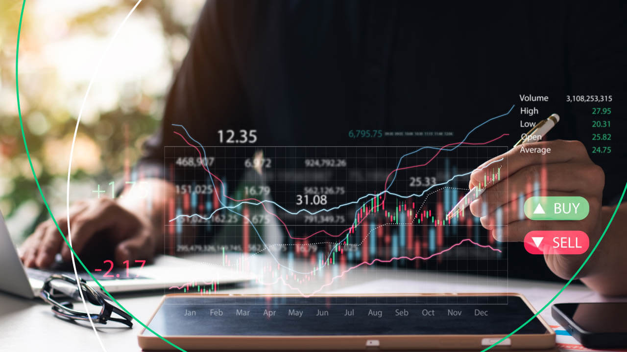 How to Overcome Fear When Trading — a trader analyzing financial charts with a stylus on a digital screen.
